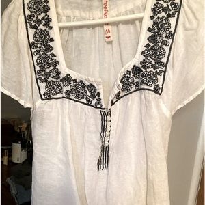 Free people blouse. Pretty embroidery around neck and flutter sleeves.